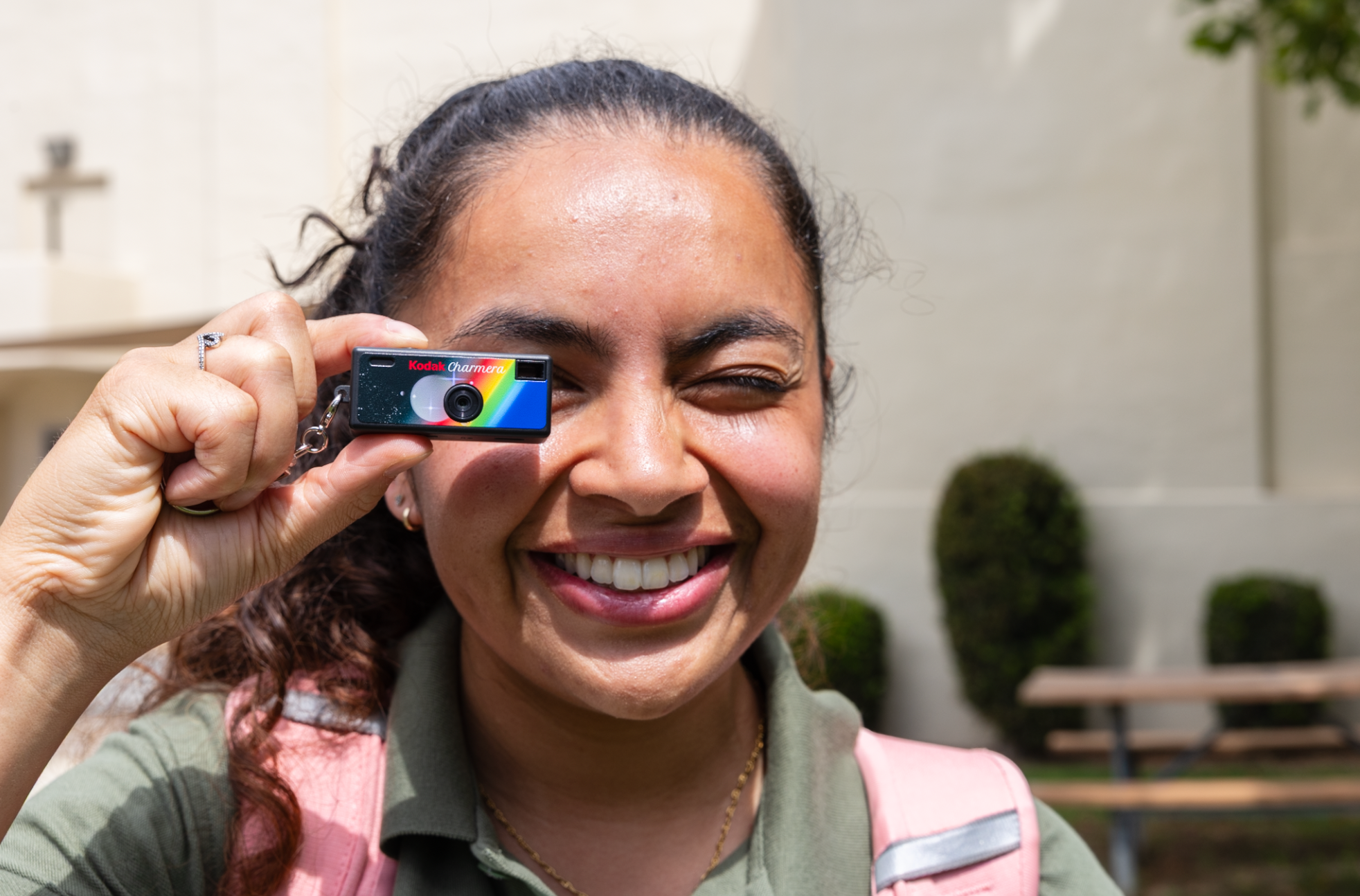 Pharmacy student holding mini camera to her eye 