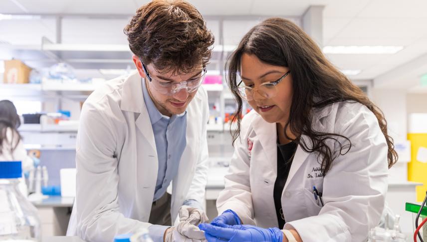young pharmacist wearing gloves and glasses
