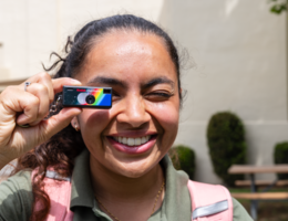 Pharmacy student holding mini camera to her eye 