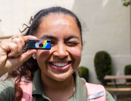 Pharmacy student holding mini camera to her eye 
